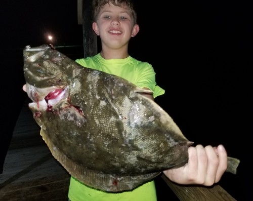 BOY WITH LARGE FLOUNDER