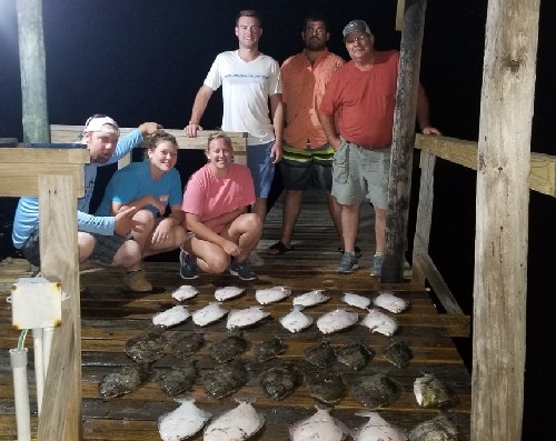 LARGE YOUNG GROUP WITH FLOUNDER